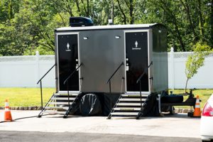 luxury porta potty trailer near a fence
