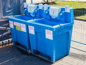 Portable hand washing station near a fence